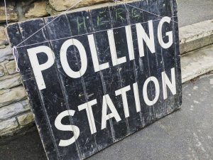 A black board with the words "polling station"